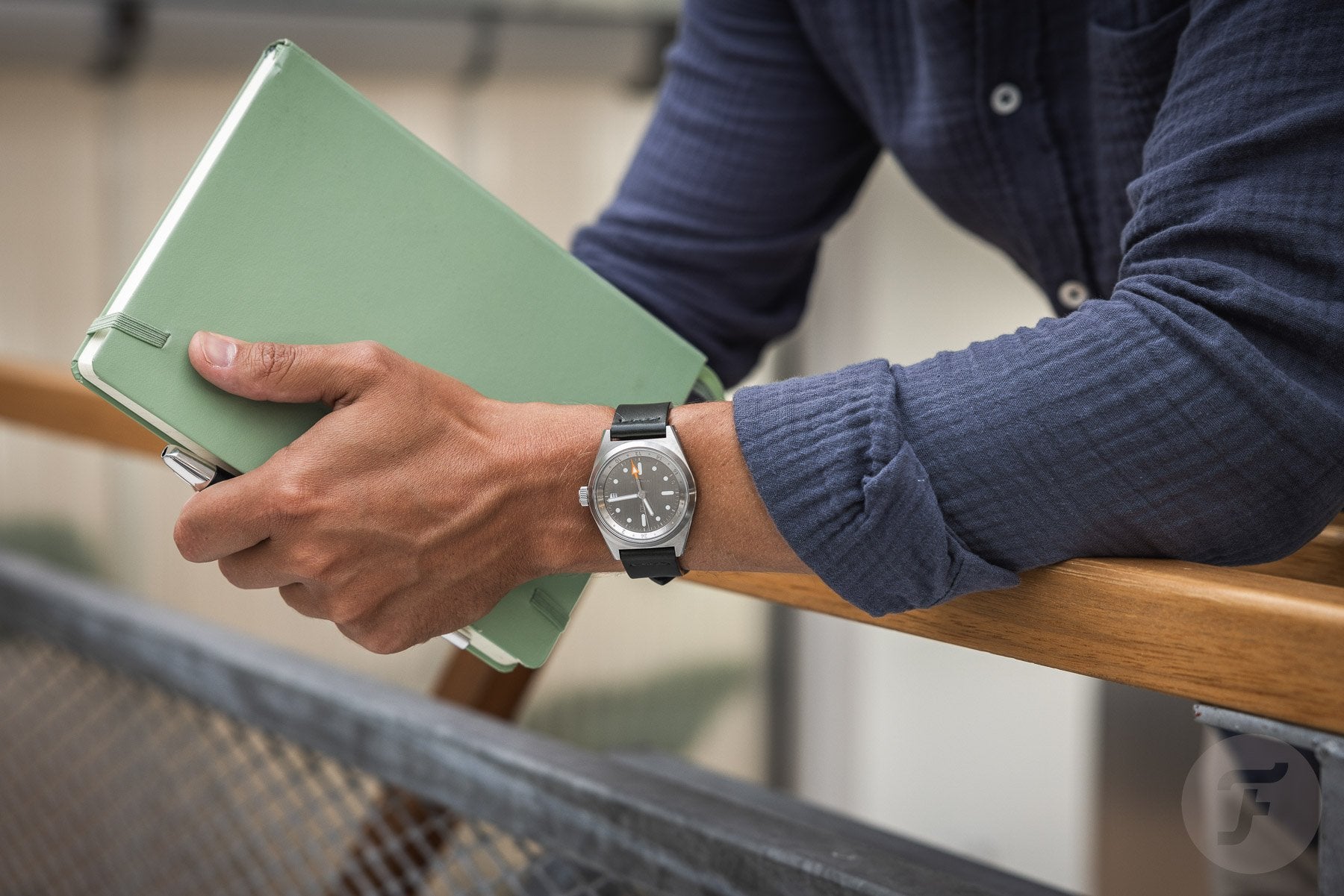Raw and naked tool watch worn with elegance style, book in hands