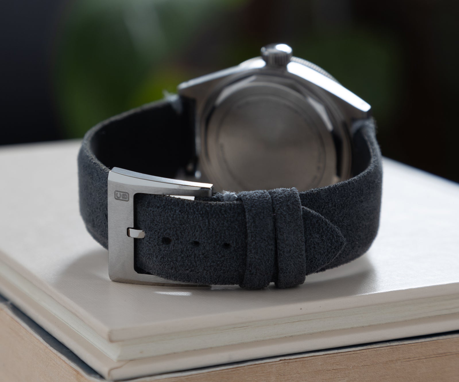 Alcantara strap and buckle of the CB01 Ti on a book