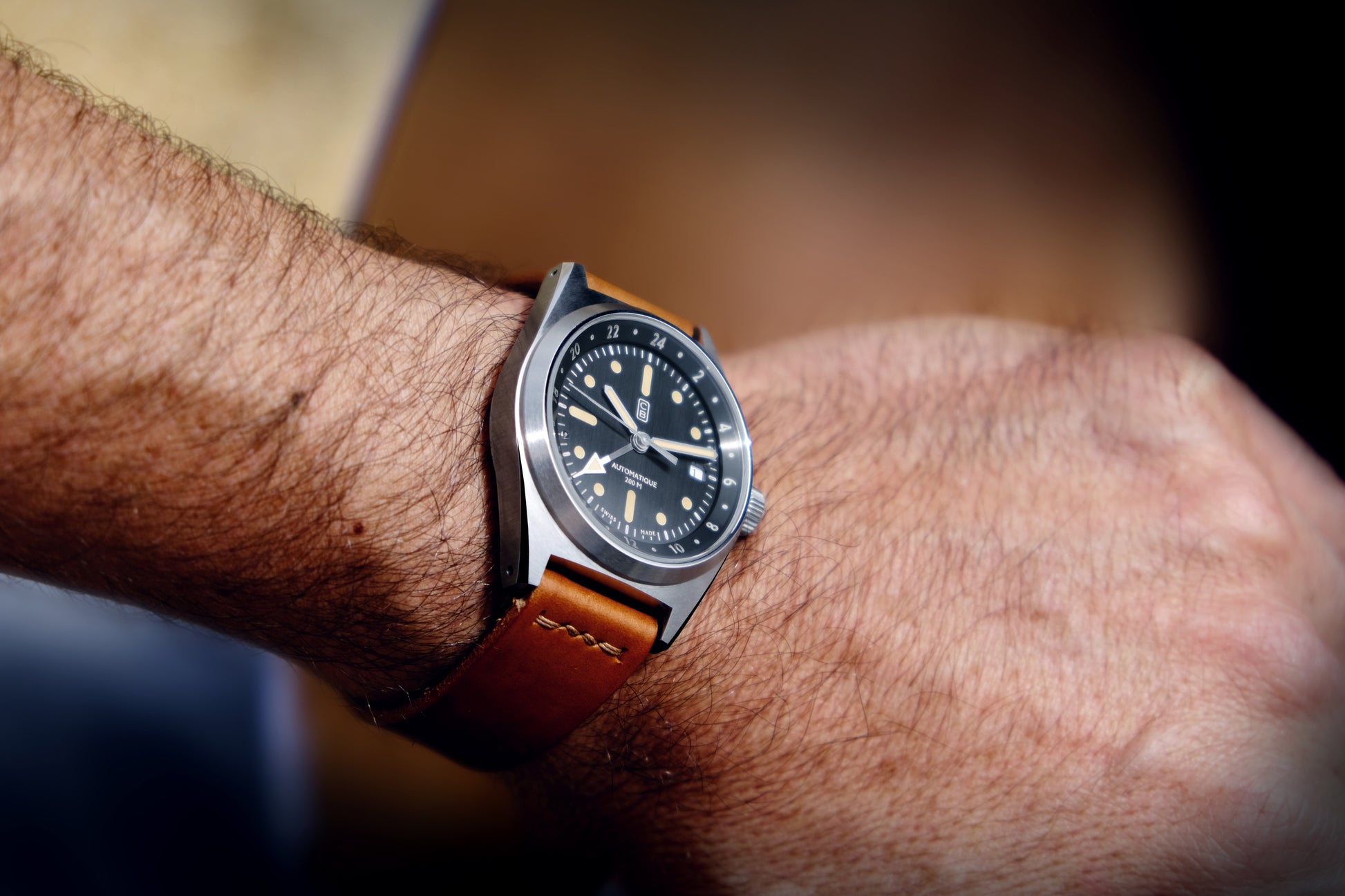 GMT watch worn taking light. Men wrist, authentic ambiance