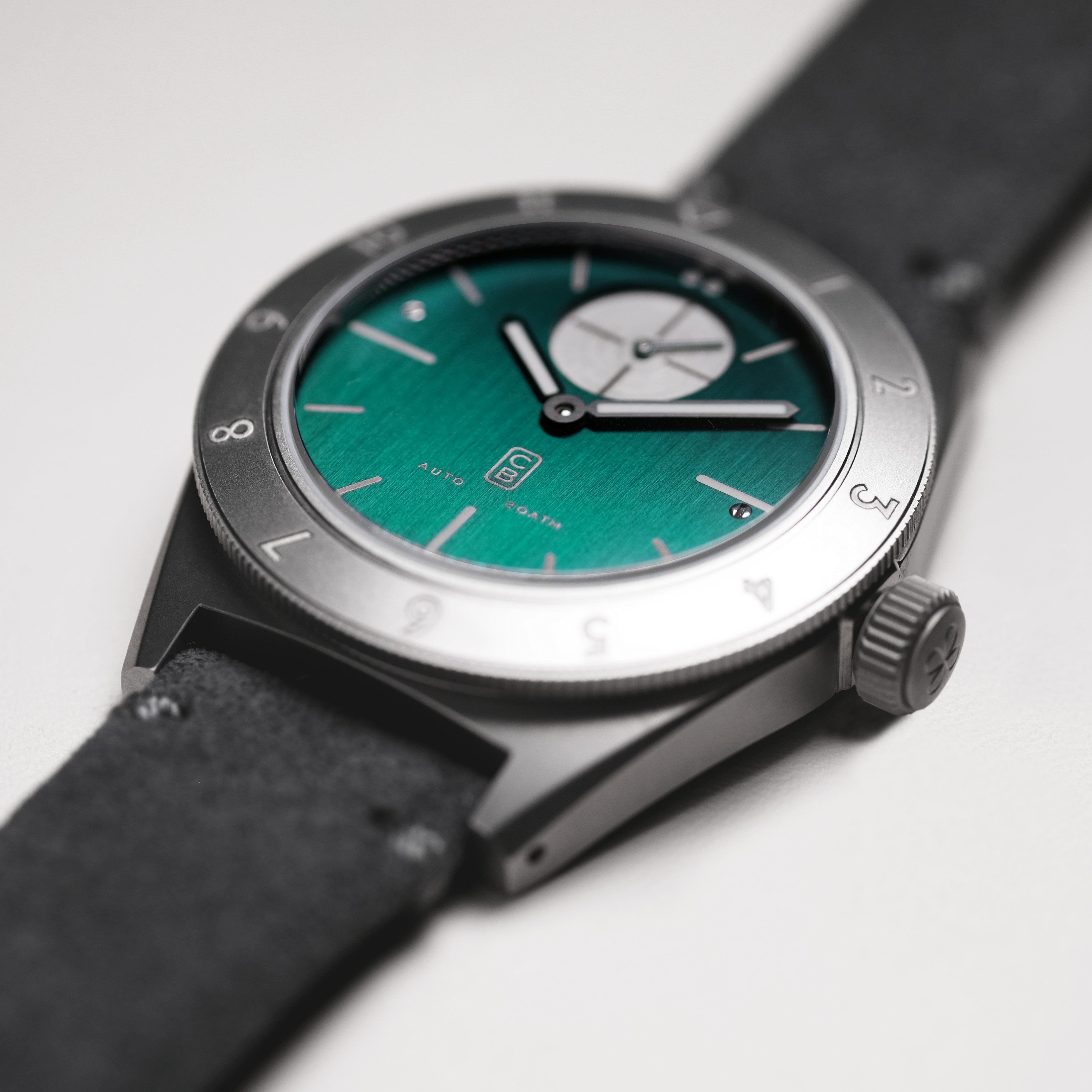 Closeup on the bottle green dial made of titanium. Swiss made. Automatic movement