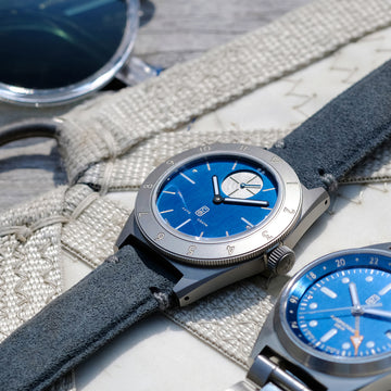 Swiss made Cedric Bellon watches with their blue dials, marine theme, on sail boat