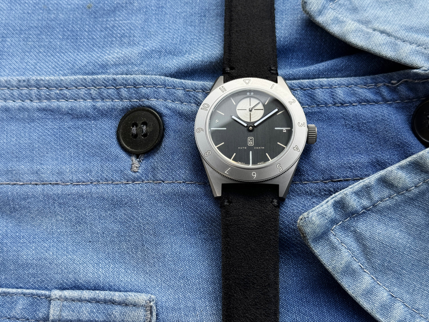 Cedric Bellon CB01 watch made of repurposed titanium on a blue denim shirt