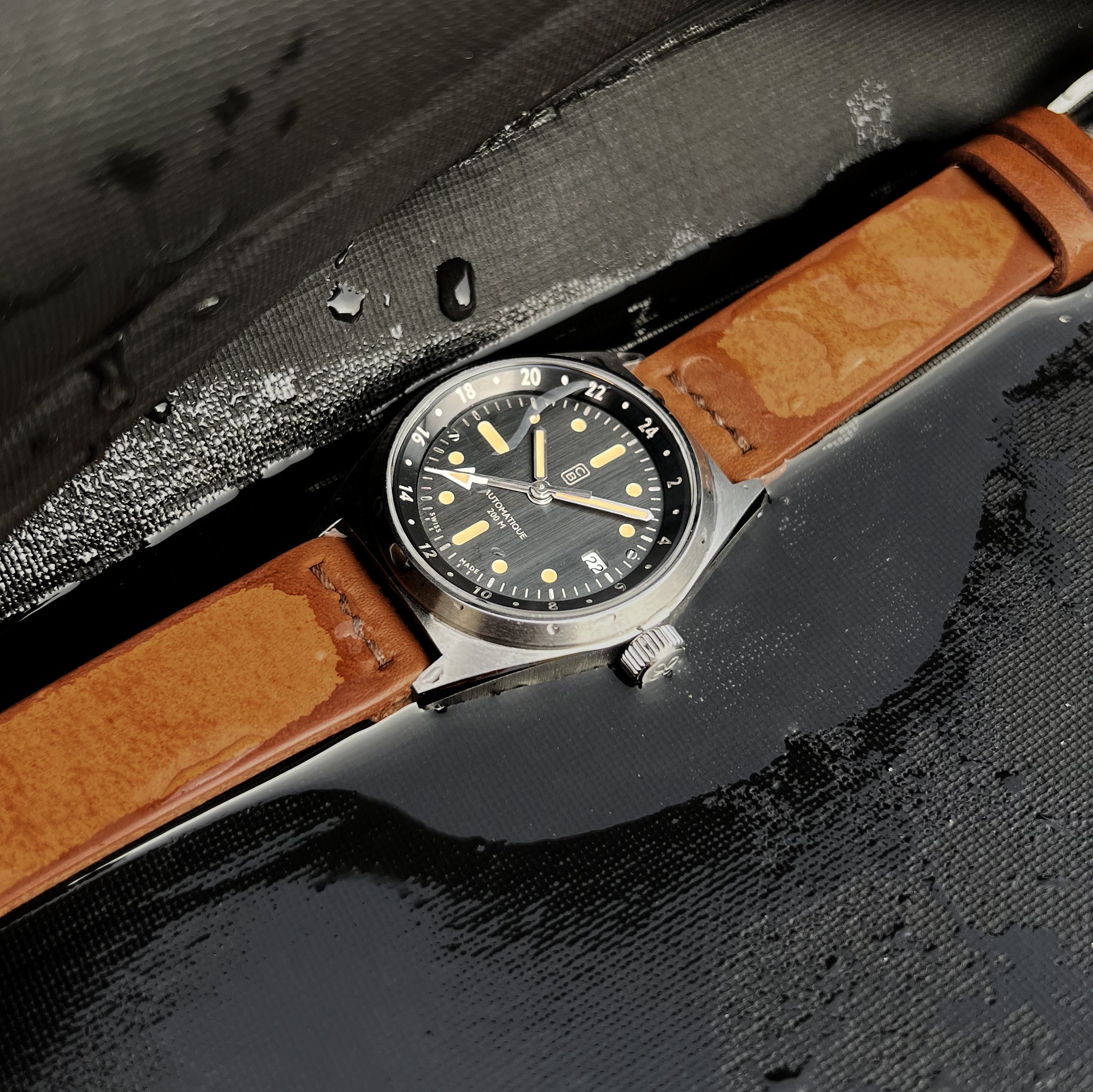 GMT tool watch 200m water resistant on a wet diver's suit