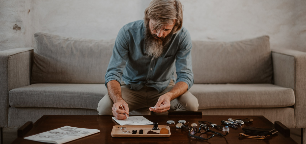 Cedric Bellon watch designer in cozy ambiance drawing and examinating Swiss made watches