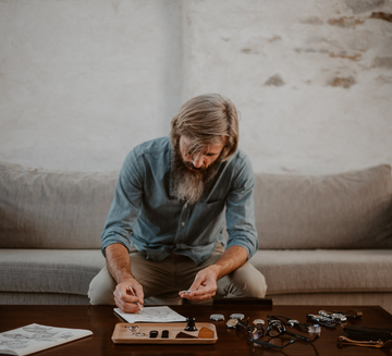 Cedric Bellon, watch designer and founder of his own watch brand, drawing a watch and examinating Swiss made watches