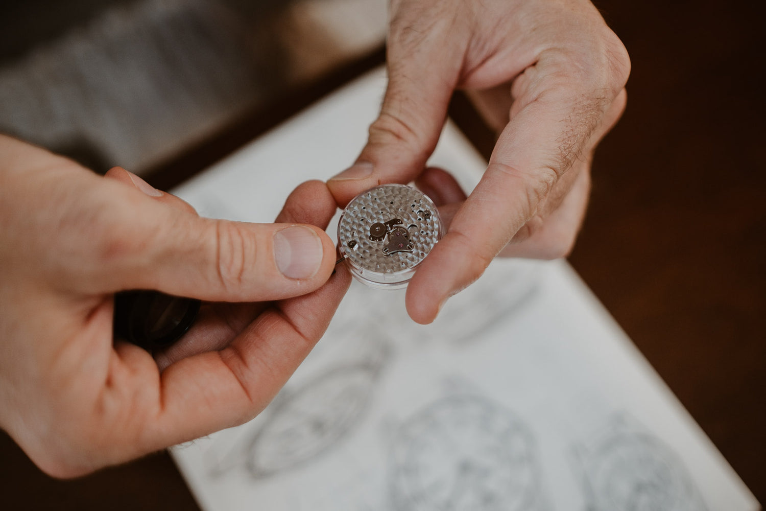 A Swiss made mechanical watch caliber hold in hands, natural and authentic environment