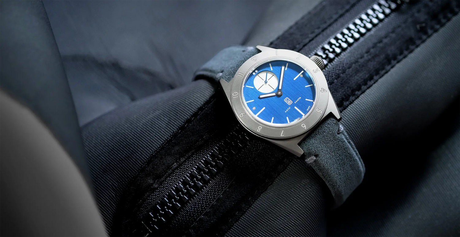 Blue dial Swiss made watch made of repurposed titanium on a diver suit | Cedric Bellon
