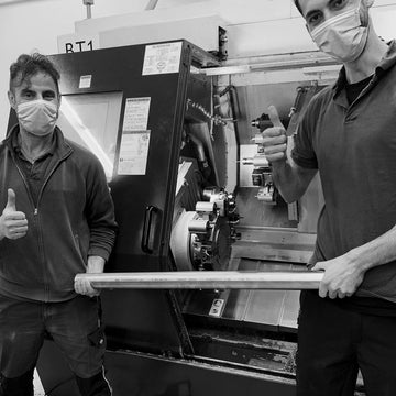 Technicians holding the first full recycled stainless steel called PuReSteel